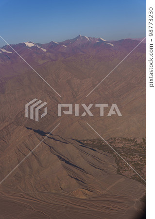 View from the plane to the surface of the earth with a mountain landscape of the Himalayas at Ladakh, India 98773230
