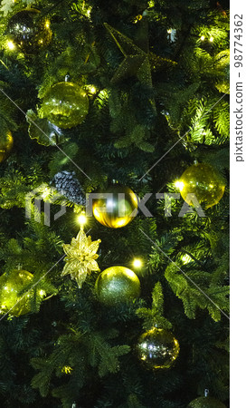 Decorative golden balls on the Christmas tree 98774362