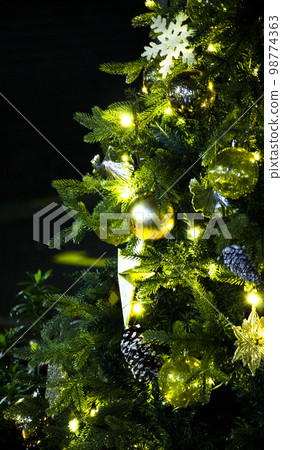 Decorative golden balls on the Christmas tree 98774363