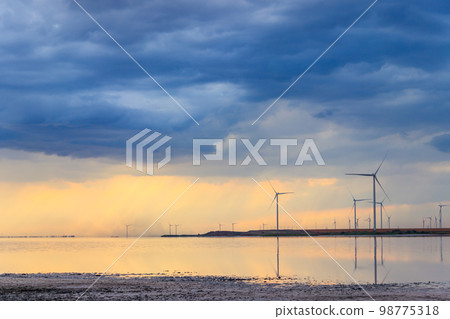Wind turbines on a shore of the pink salty Syvash lake in Kherson region, Ukraine. Renewable energy Wind turbines on a shore of the pink salty Syvash lake in Kherson region, Ukraine. Renewable energy 98775318