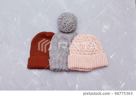 Knitted surface of woolen things as a background. Close-up of soft fabric red color knitted patterns texture. Warm winter clothing. Background textile surface with copy space for text 98775363