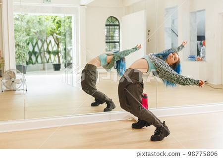 Image of caucasian female hip hop dancer practicing at dance studio 98775806