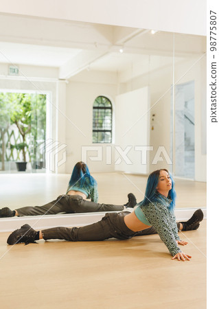 Vertical image of caucasian female hip hop dancer practicing at dance studio with copy space Vertical image of caucasian female hip hop dancer practicing at dance studio with copy space 98775807
