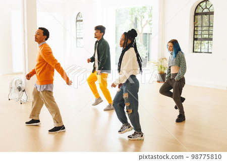 Image of diverse female and male hip hop dancers during training in dance club Image of diverse female and male hip hop dancers during training in dance club 98775810