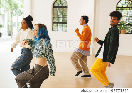 Image of diverse female and male hip hop dancers during training in dance club Image of diverse female and male hip hop dancers during training in dance club 98775811
