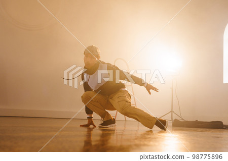 Image of biracial male modern dancer dancing in smoked interior 98775896