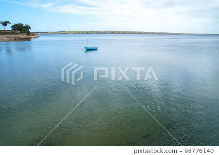 A boat in a calm cove 98776140