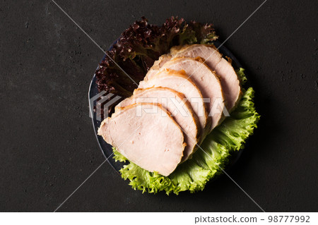 Delicious juicy sliced ham with lettuce 98777992