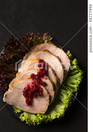 Delicious juicy sliced ham with lettuce with acid sweet lingonberry sauce 98777999