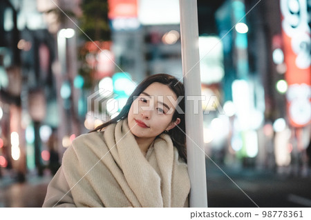 woman leaning on pole woman leaning on pole 98778361