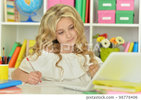 girl using laptop at desk at home 98778406