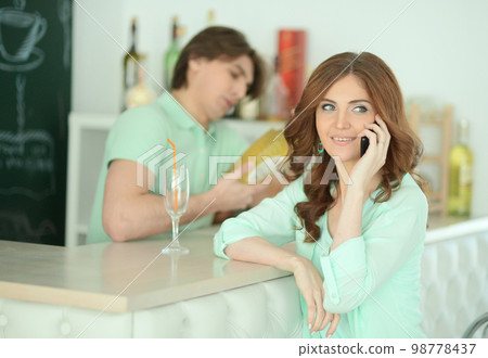 Young woman waiting for drink 98778437