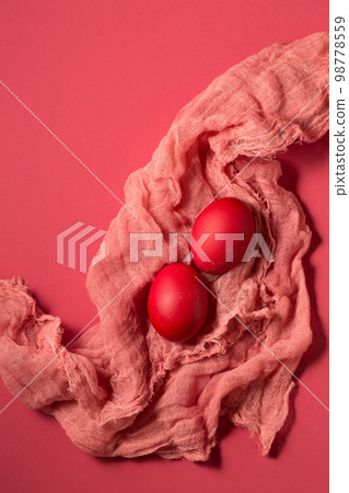 Pink eggs on pink gauze on a pink background Pink eggs on pink gauze on a pink background 98778559