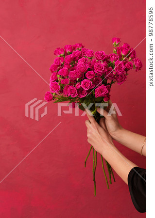 Beautiful bouquet of pink roses in female hands Beautiful bouquet of pink roses in female hands 98778596