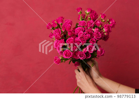 bouquet of pink roses in female hands bouquet of pink roses in female hands 98779113