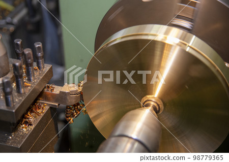 The lathe machine finish cut the brass parts by lathe tools. The lathe machine finish cut the brass parts by lathe tools. 98779365
