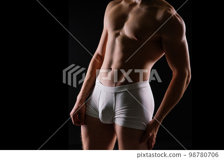 Shirtless bodybuilder holding dumbell and showing his muscular arms. Shirtless bodybuilder holding dumbell and showing his muscular arms. 98780706