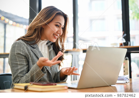 Professional Asian businesswoman pitching new project through online video conference. Professional Asian businesswoman pitching new project through online video conference. 98782462