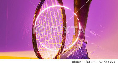 Illuminated circle and plants over cropped leg of african american male tennis player with racket 98783555