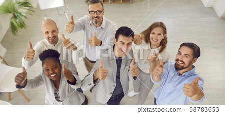 Banner with team of happy business people standing in office, smiling and giving thumbs up Banner with team of happy business people standing in office, smiling and giving thumbs up 98783653