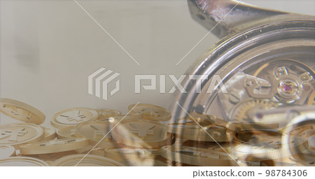 Financial data processing over close up of a watch and yen gold coins against grey background Financial data processing over close up of a watch and yen gold coins against grey background 98784306