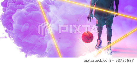 Low section of african american male player with basketball by triangle on smoky background Low section of african american male player with basketball by triangle on smoky background 98785687