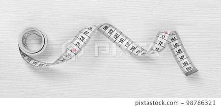 Measuring tape isolated on a white wooden background Measuring tape isolated on a white wooden background 98786321