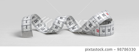 Measuring tape isolated on a white wooden background 98786330