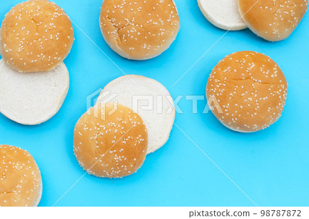 Hamburger buns with sesame on blue background. Hamburger buns with sesame on blue background. 98787872
