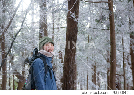 woman climbing snow mountain woman climbing snow mountain 98788403