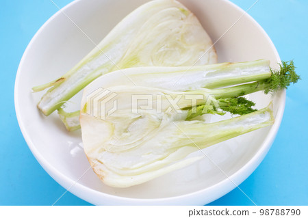 Fresh fennel bulb on blue background Fresh fennel bulb on blue background 98788790