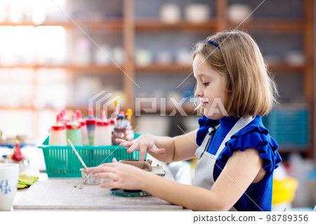 Child at pottery wheel. Kids arts and crafts class 98789356
