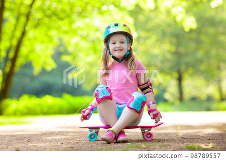 Child riding skateboard in summer park Child riding skateboard in summer park 98789557