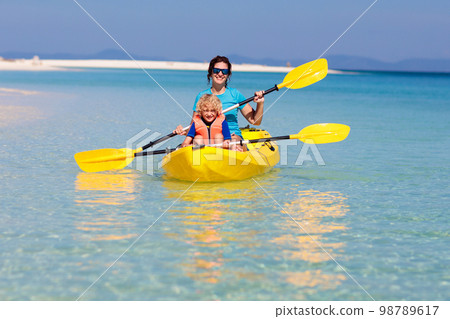 Kids kayaking in ocean. Family in kayak in tropical sea 98789617
