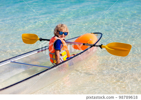Kids kayaking in ocean. Family in kayak in tropical sea 98789618