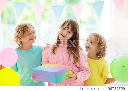 Kids birthday party. Child blowing out cake candle Kids birthday party. Child blowing out cake candle 98789769