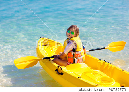 Kids kayaking in ocean. Family in kayak in tropical sea Kids kayaking in ocean. Family in kayak in tropical sea 98789773