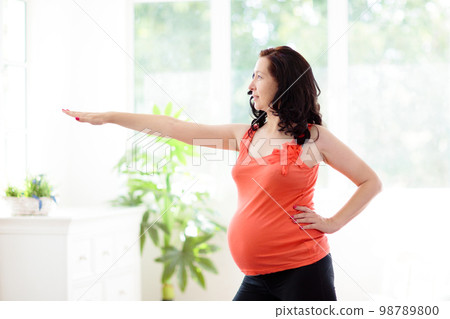 Pregnancy yoga. Exercise for pregnant woman. 98789800
