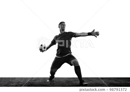 Black and white portrait of male soccer football goalkeeper psoing isolated over white background. Monochrome. Concept of sport, action, motion, goals. Black and white portrait of male soccer football goalkeeper psoing isolated over white background. Monochrome. Concept of sport, action, motion, goals. 98791372
