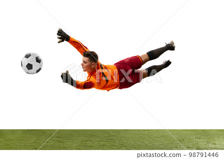 Young man, soccer football goalkeeper catches ball in jump isolated over white background. Concept of sport, action, motion, goals. Young man, soccer football goalkeeper catches ball in jump isolated over white background. Concept of sport, action, motion, goals. 98791446
