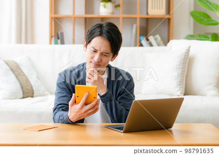 Worried man calculator life plan Worried man calculator life plan 98791635