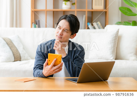 Worried man calculator life plan 98791636