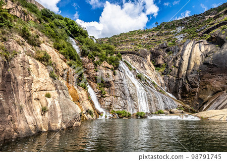 Ezaro waterfall, Galicia, Northern Spain in Spring. It empties into the Atlantic ocean in a waterfall 98791745