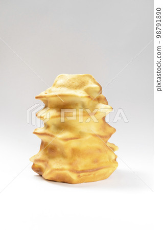 Isokated Sakotis ,sekacz, baumkuchen, traditional spit cake in lithuanian, polish, german, belarusian cuisine made of butter,eggs,flour,sugar, cooked over open fire on white background Vertical 98791890