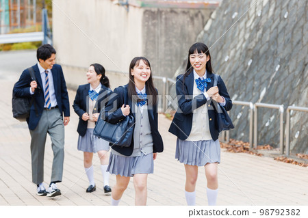 High school student going to school with friends High school student going to school with friends 98792382