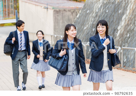 High school student going to school with friends High school student going to school with friends 98792635