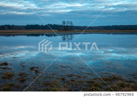 The reflection of the sky in the water on a meadow in eastern Poland The reflection of the sky in the water on a meadow in eastern Poland 98792968