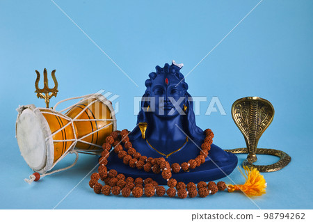 Shivaratri background with Shivas trident, Pellet Drum Damroo musical instrument ans snake . Maha Shivratri festval 98794262