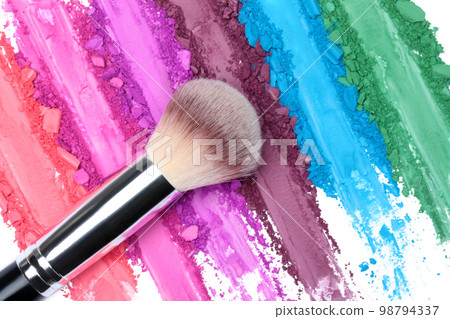 Broken and smashed color make-up eyeshadow palette, lay of brush strokes with brush, close-up for background, top view Broken and smashed color make-up eyeshadow palette, lay of brush strokes with brush, close-up for background, top view 98794337