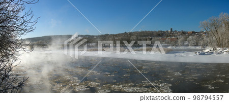 Sherbrooke Quebec Canada, winter landscape cold temperature frozen river mist and fog ice water panorama Sherbrooke Quebec Canada, winter landscape cold temperature frozen river mist and fog ice water panorama 98794557